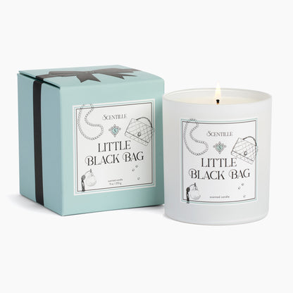 A Little Black Bag candle next to its box