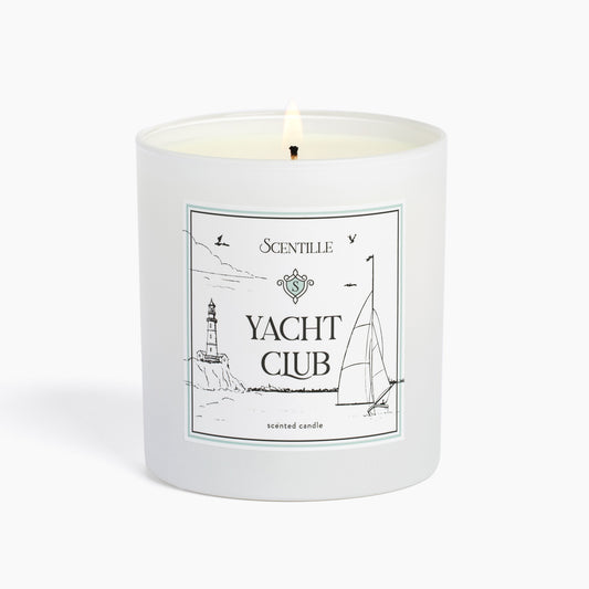 A lit Yacht Club candle from Scentille